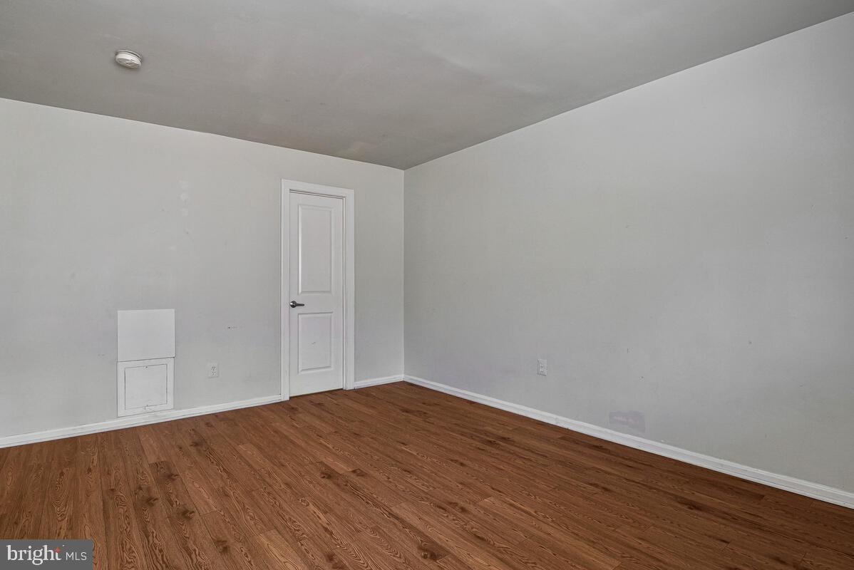 3103 Naylor Road Southeast, Unit 304 Washington, DC 20020 - Photo 25 of 28 a view of empty room with wooden floor