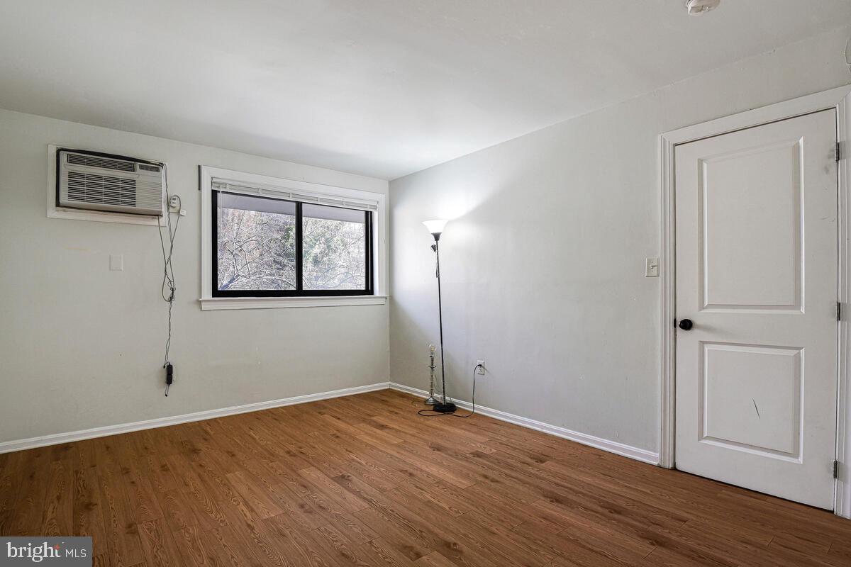 3103 Naylor Road Southeast, Unit 304 Washington, DC 20020 - Photo 27 of 28 a view of empty room with wooden floor and fan