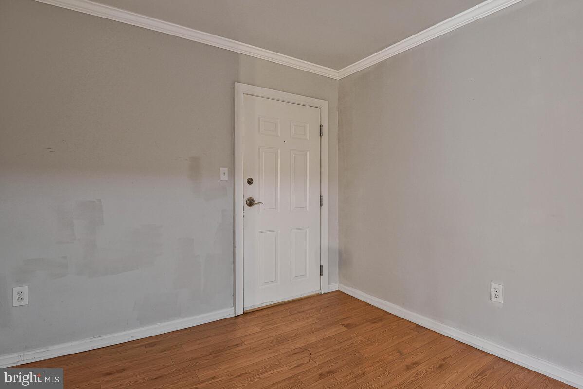 3103 Naylor Road Southeast, Unit 304 Washington, DC 20020 - Photo 6 of 28 a view of an empty room with wooden floor