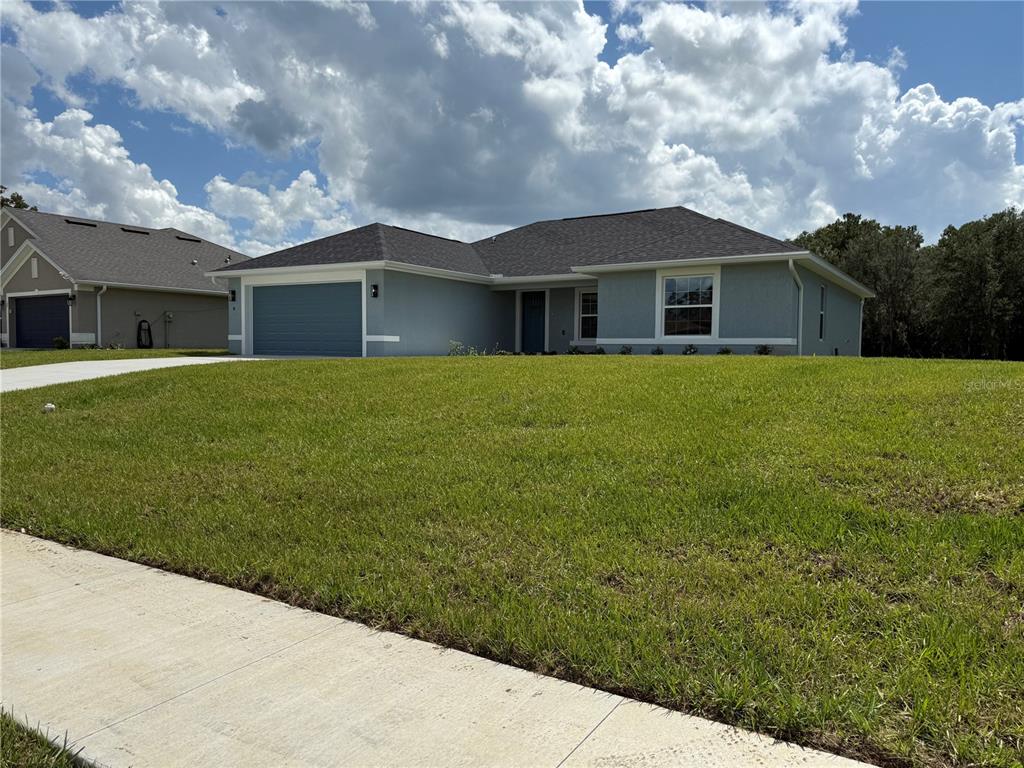 19 Northwest 45th Loop Ocala, FL 34475 - Photo 14 of 28 a front view of a house with garden