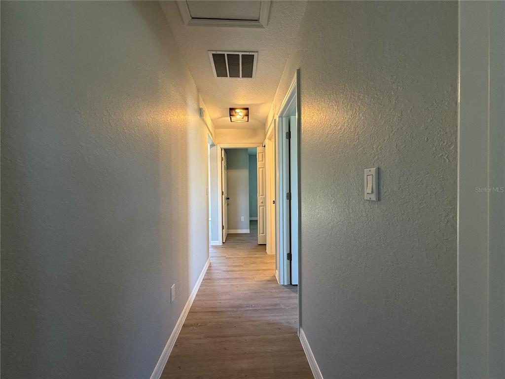 19 Northwest 45th Loop Ocala, FL 34475 - Photo 17 of 28 a view of a hallway with wooden floor