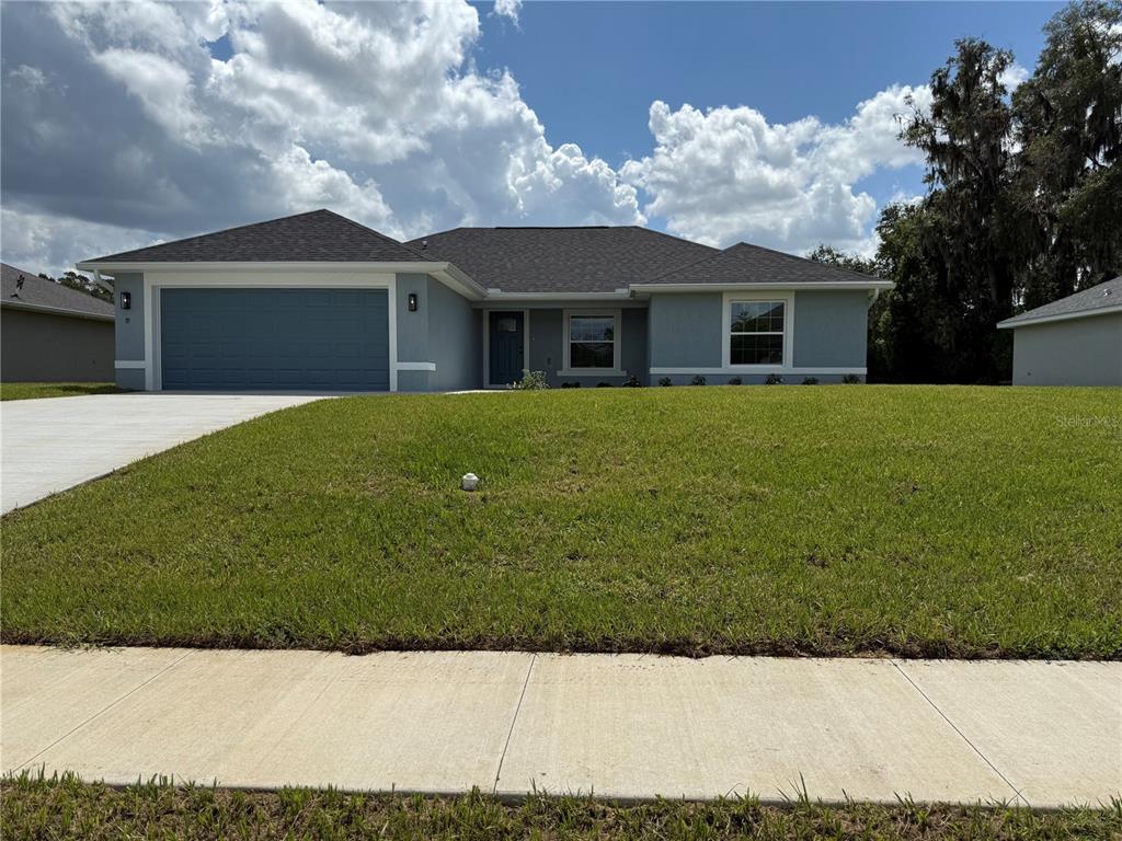 19 Northwest 45th Loop Ocala, FL 34475 - Photo 2 of 28 a front view of a house with a garden