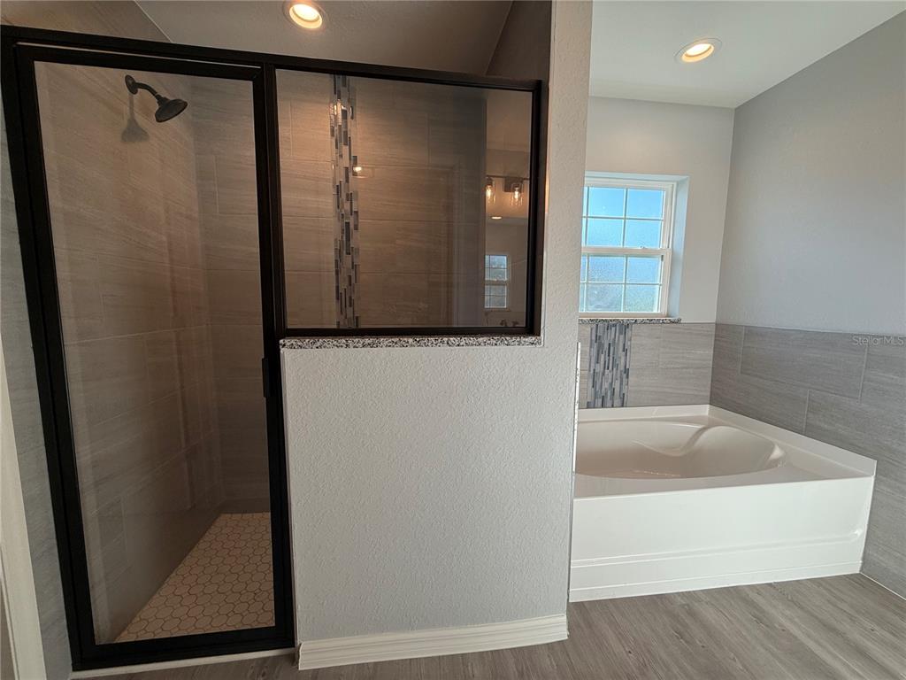 19 Northwest 45th Loop Ocala, FL 34475 - Photo 22 of 28 a bathroom with a shower and a mirror