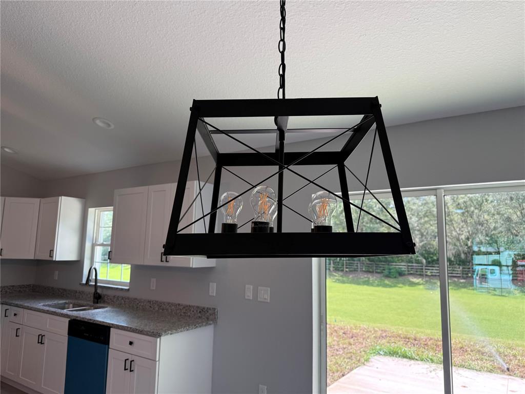 19 Northwest 45th Loop Ocala, FL 34475 - Photo 23 of 28 a kitchen with a sink a window and cabinets