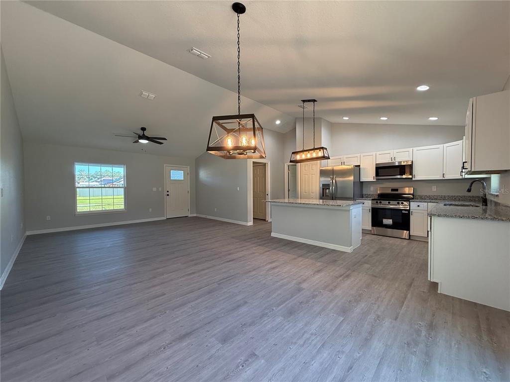 19 Northwest 45th Loop Ocala, FL 34475 - Photo 6 of 28 a view of a kitchen with microwave and stove