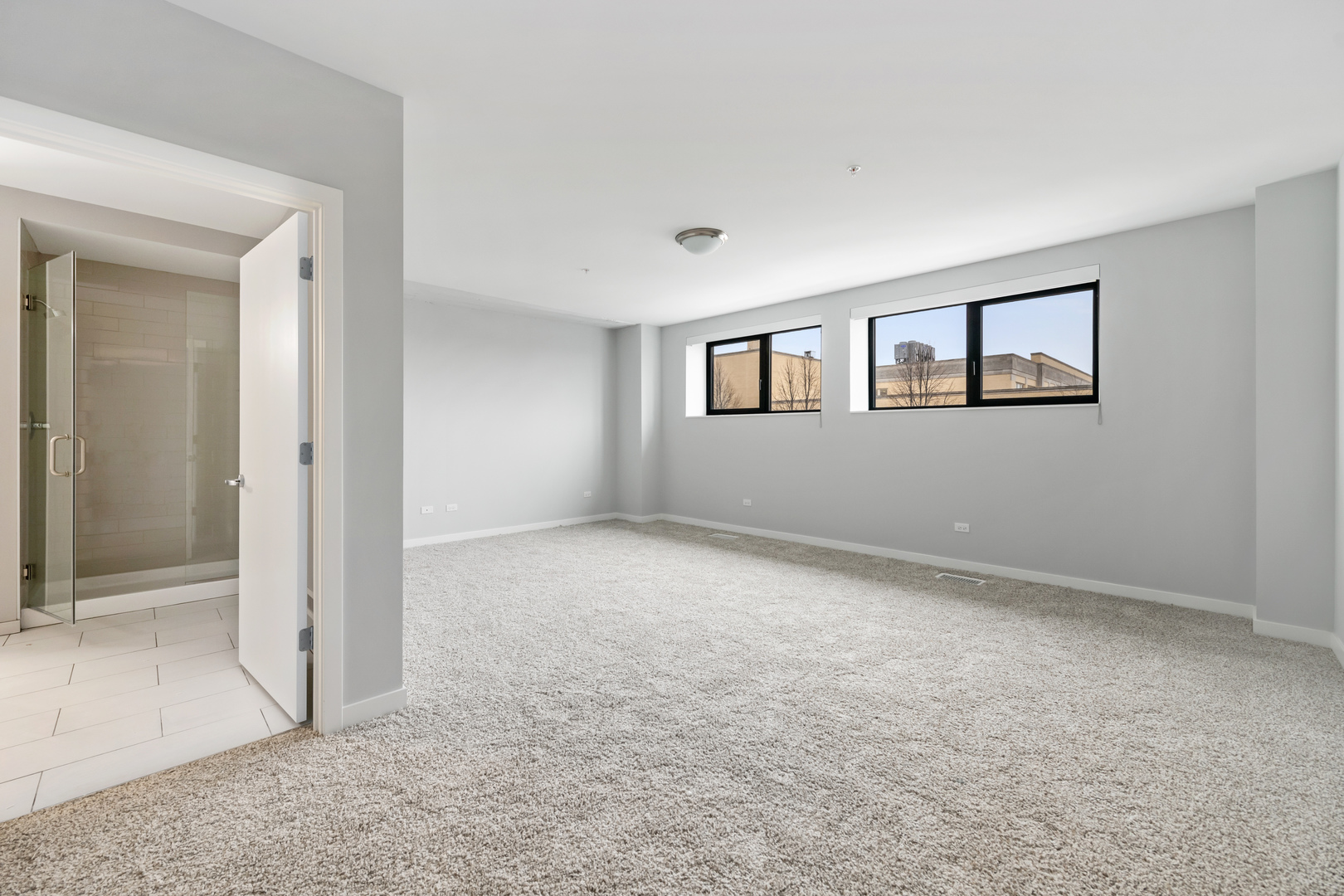 1900 West Lawrence Avenue, Unit 231 Chicago, IL 60640 - Photo 11 of 23 an empty room with windows and closet