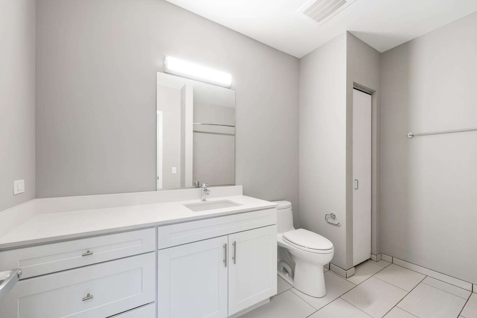 1900 West Lawrence Avenue, Unit 231 Chicago, IL 60640 - Photo 19 of 23 a bathroom with a toilet sink and mirror