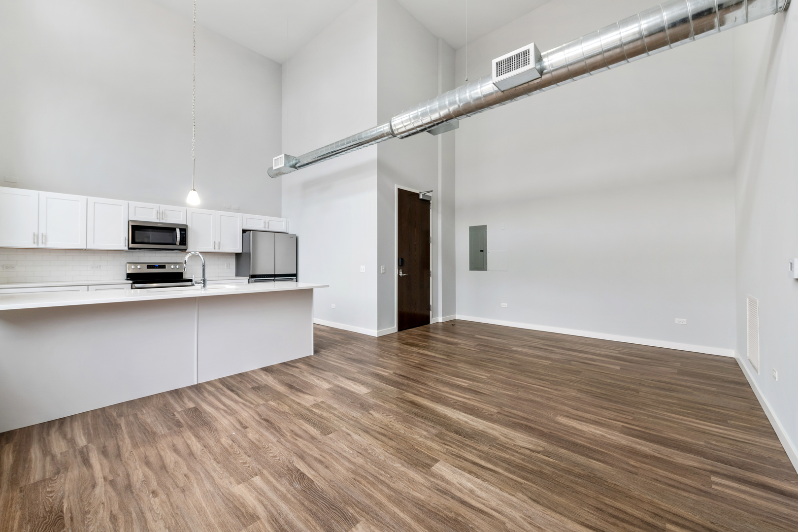 1900 West Lawrence Avenue, Unit 231 Chicago, IL 60640 - Photo 3 of 23 a view of kitchen with stainless steel appliances refrigerator stove microwave and cabinets