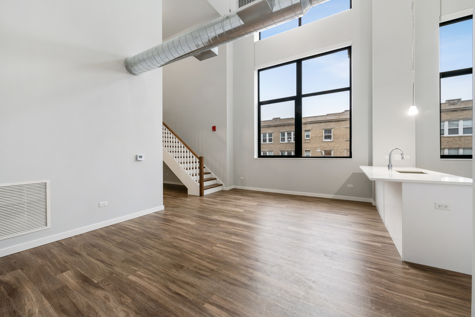 1900 West Lawrence Avenue, Unit 231 Chicago, IL 60640 - Photo 5 of 23 a view of an empty room with a window and wooden floor