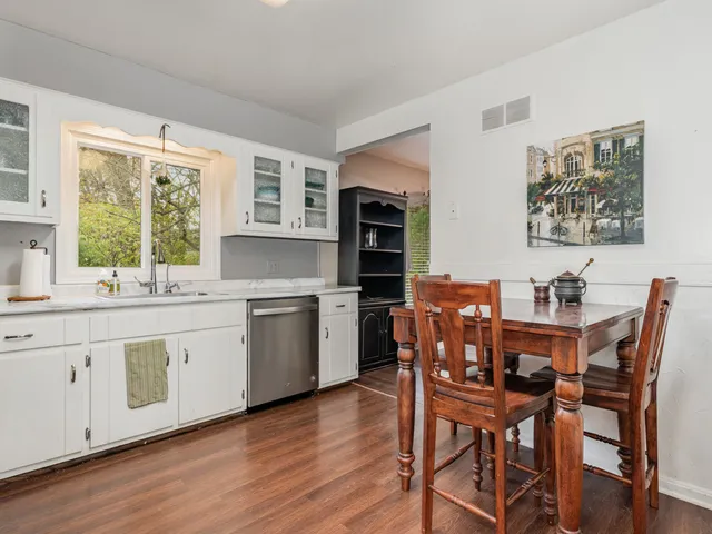 a view of a dining room with furniture and wooden floor