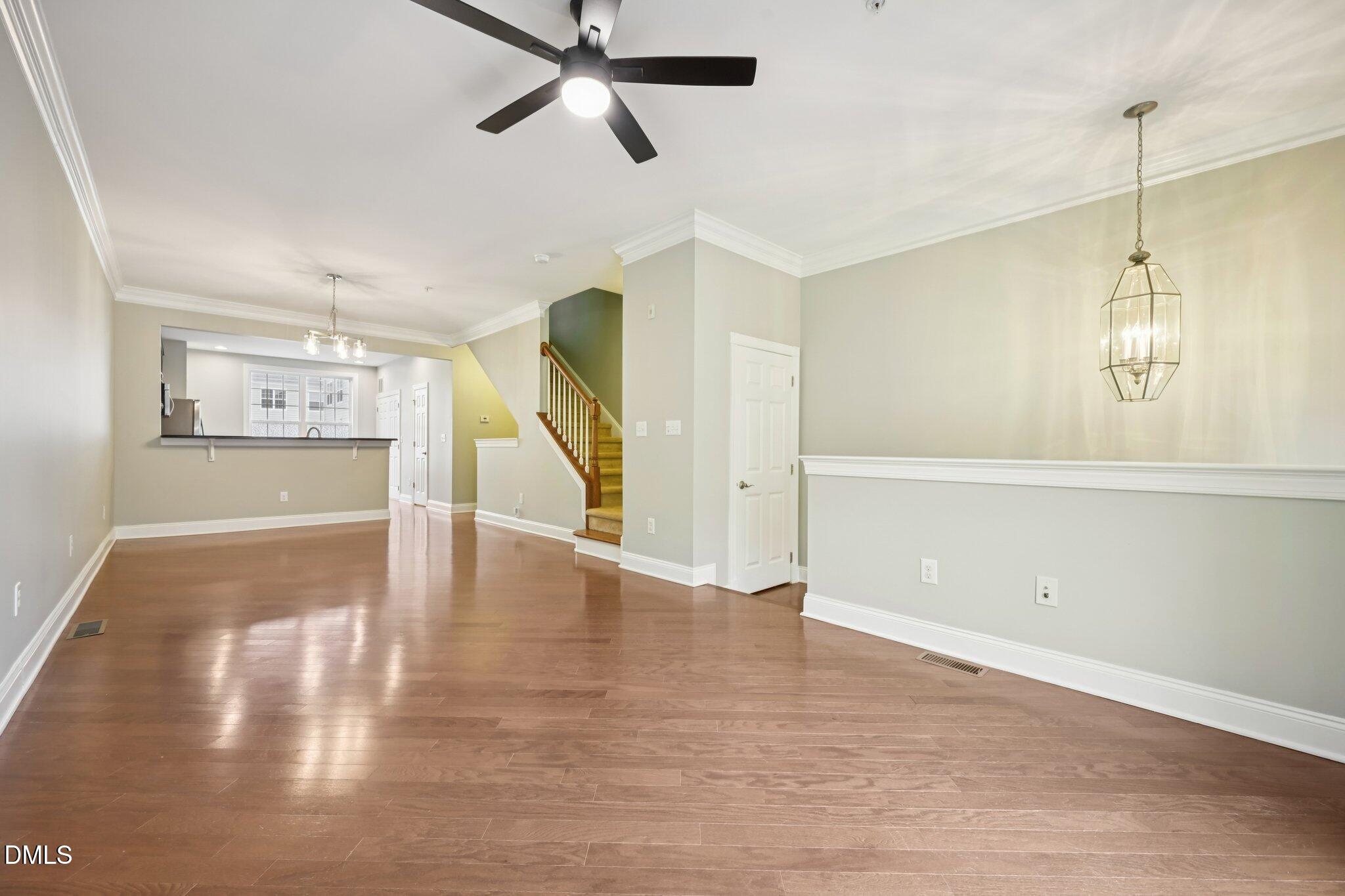 10510 Sablewood Drive, Unit 113 Raleigh, NC 27617 - Photo 7 of 38 a view of a livingroom with wooden floor and a ceiling fan