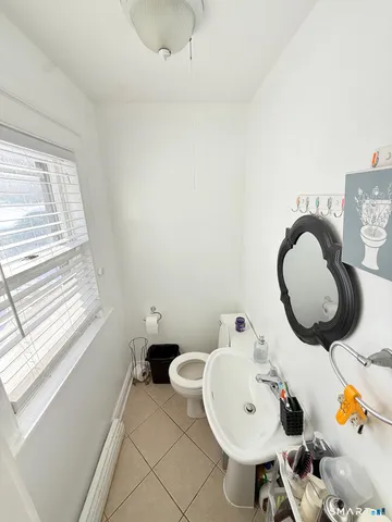 a bathroom with a sink mirror and toilet