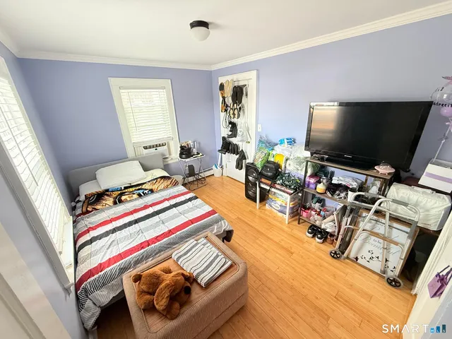 a bedroom with furniture and a flat screen tv