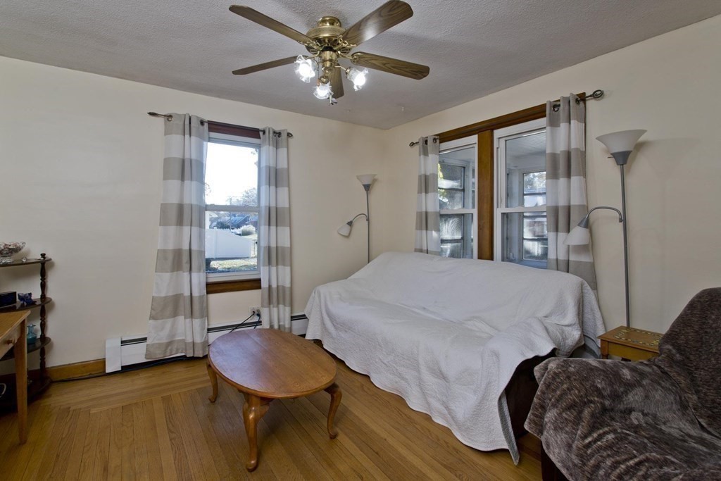 129 Eddy Street Springfield, MA 01104 - Photo 16 of 40 a bedroom with a bed and a chandelier