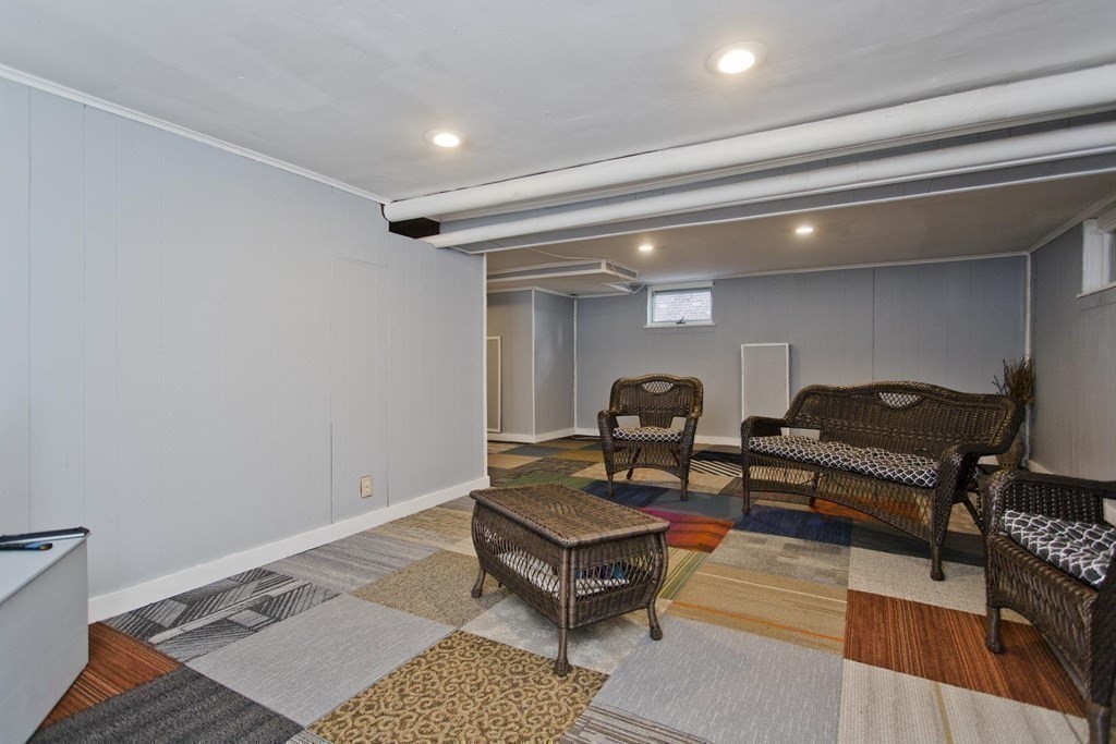 129 Eddy Street Springfield, MA 01104 - Photo 25 of 40 a living room with furniture a rug and a window