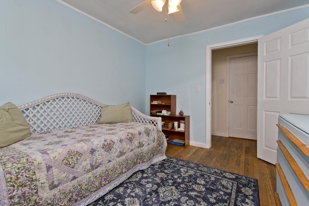129 Eddy Street Springfield, MA 01104 - Photo 9 of 40 a bedroom with a bed and wooden floor