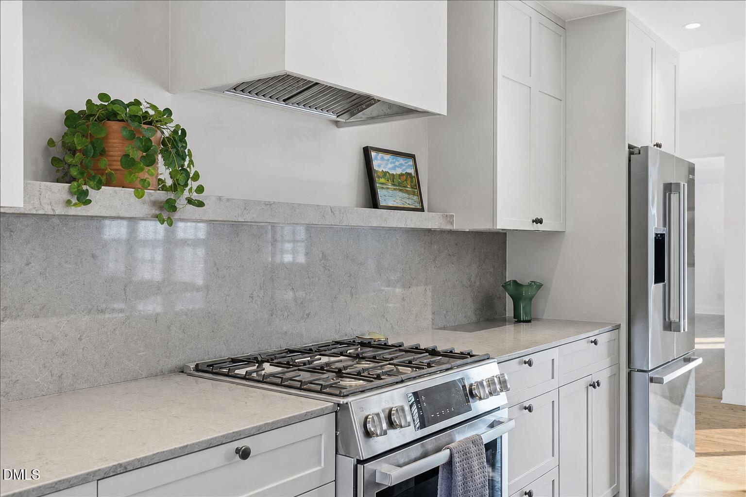 5904 Volant Drive Raleigh, NC 27609 - Photo 14 of 42 a stove top oven sitting inside of a kitchen