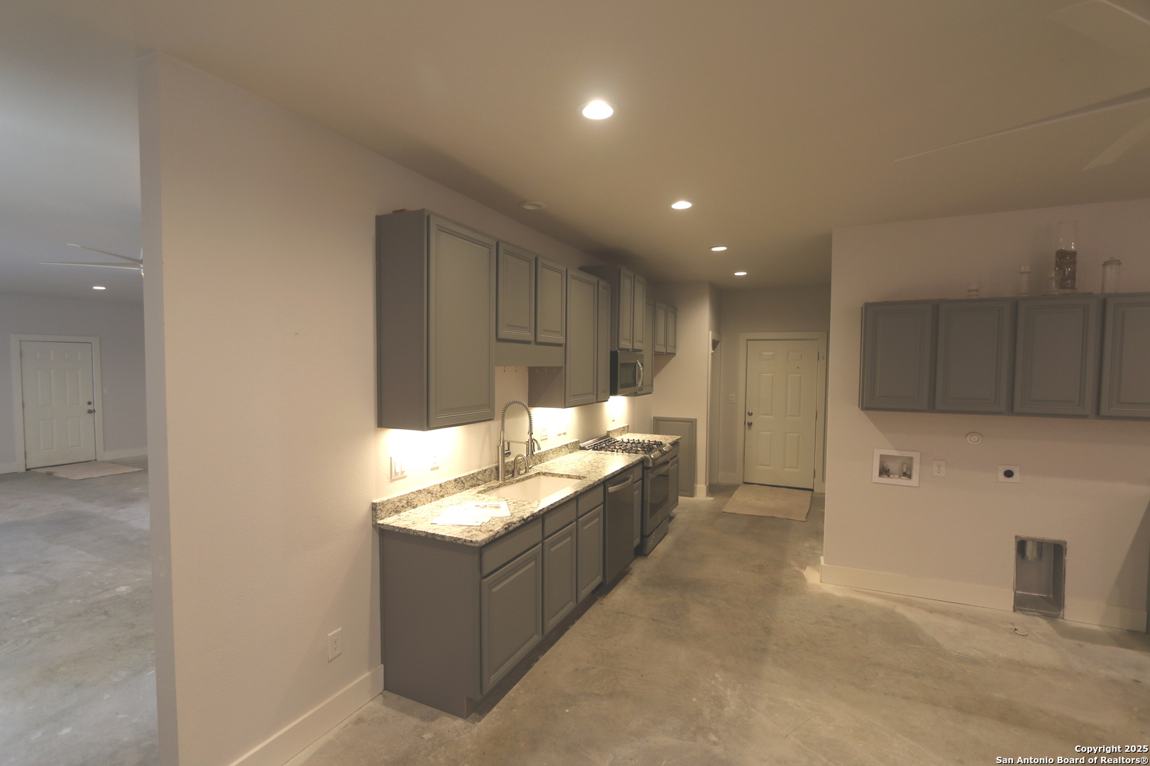 1221 North Santa Clara Road Marion, TX 78124 - Photo 28 of 55 a large kitchen with stainless steel appliances kitchen island granite countertop a refrigerator and a stove