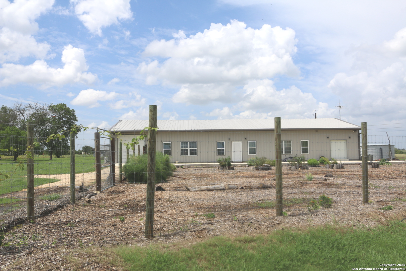 1221 North Santa Clara Road Marion, TX 78124 - Photo 4 of 55 a view of a house with a big yard and a large tree