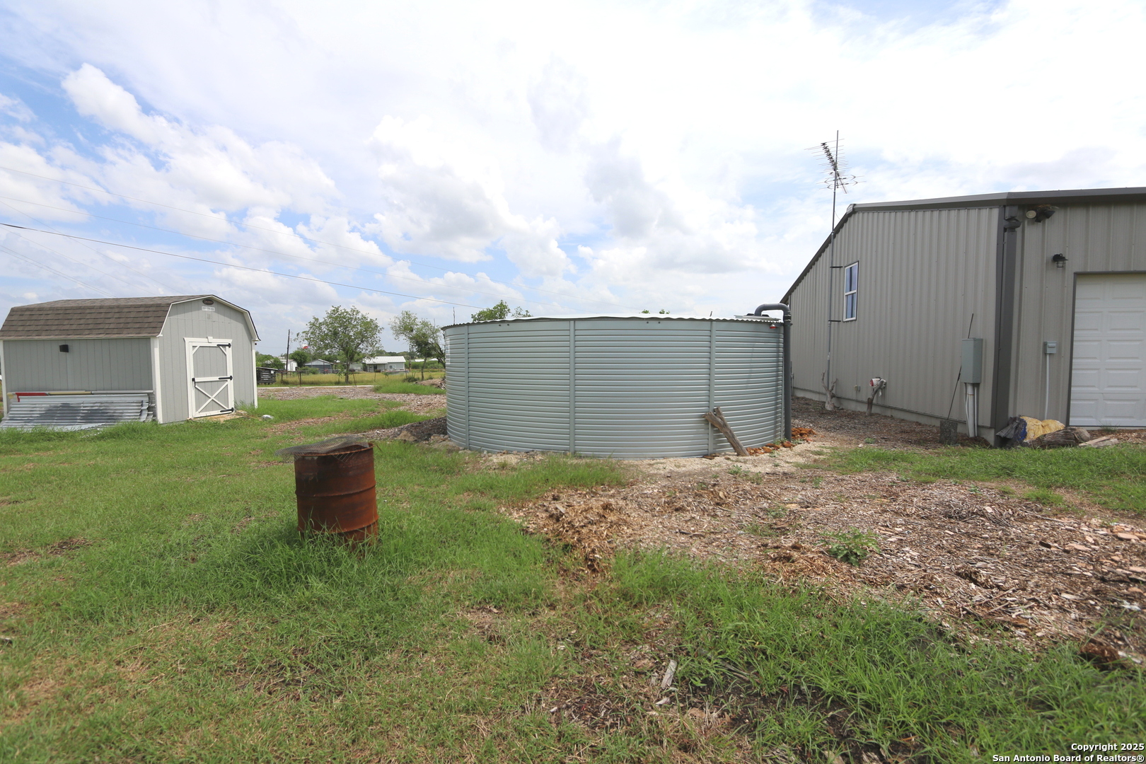 1221 North Santa Clara Road Marion, TX 78124 - Photo 45 of 55 a backyard of a house with table and chairs
