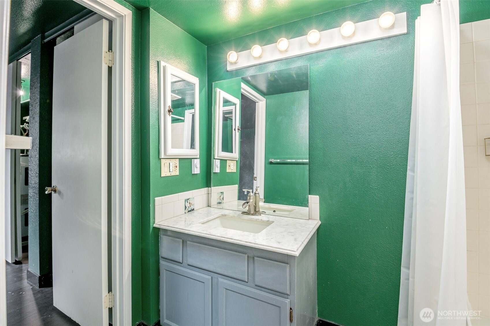 110 Southwest 116th Street, Unit A13 Seattle, WA 98146 - Photo 9 of 16 a bathroom with a double vanity sink and a mirror
