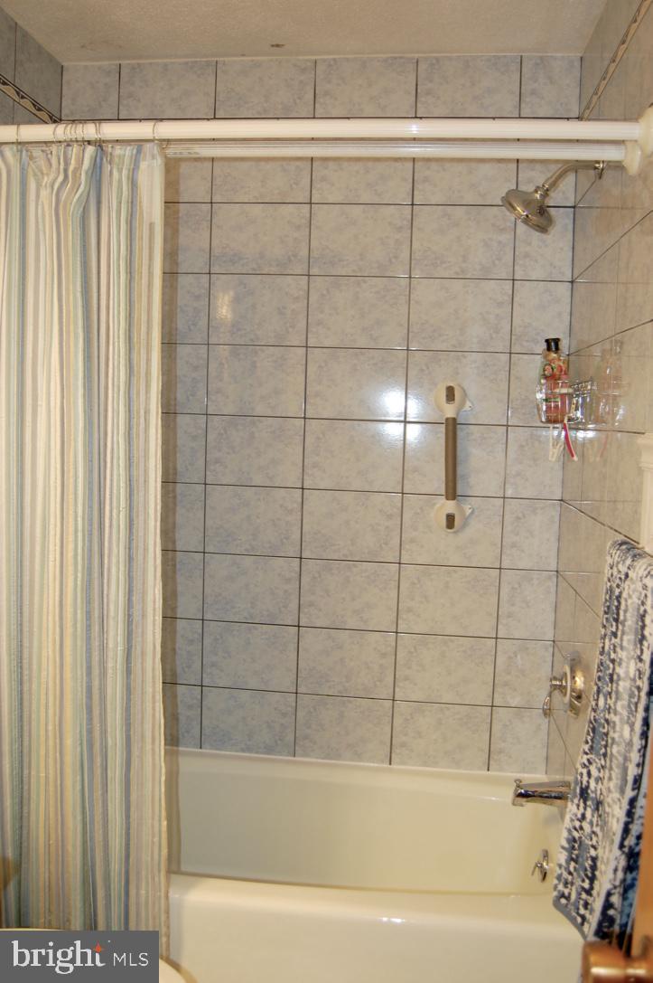 210 East 3rd Avenue Ranson, WV 25438 - Photo 13 of 33 Full bathroom off hallway with ceramic tile floor