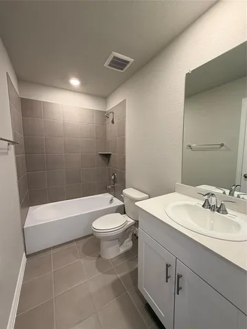 a bathroom with a sink a toilet and bathtub