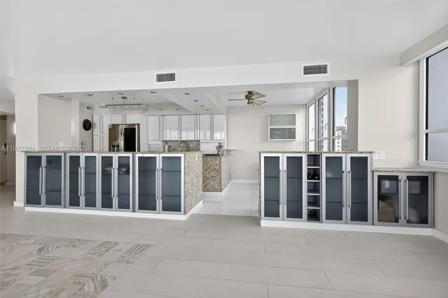 a kitchen with cabinets appliances a sink and a window