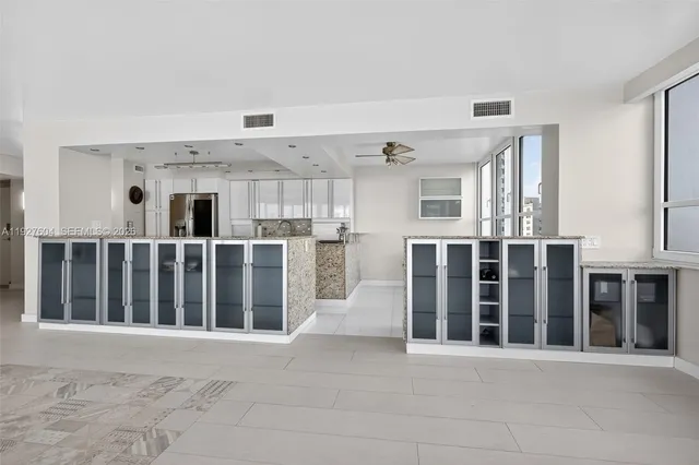 a kitchen with cabinets appliances a sink and a window
