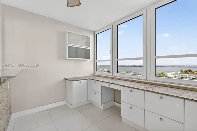 a kitchen with stainless steel appliances granite countertop a stove and cabinets