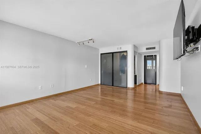 a bathroom with a granite countertop sink a mirror and a shower