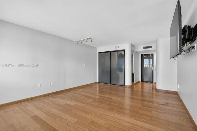 a bathroom with a granite countertop sink a mirror and a shower