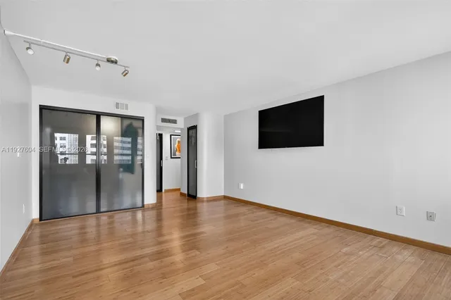 a room with a large window and furniture