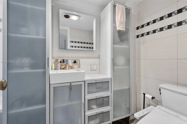 a view of staircase with railing and white walls