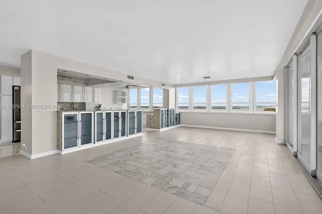 a view of an empty room with glass door