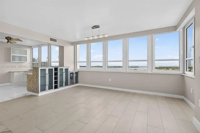 a large white room with windows and chandelier