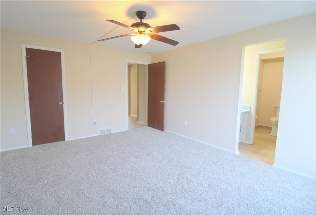 6476 State Road Cleveland, OH 44134 - Photo 14 of 26 Primary Bedroom with Neutral Paint, Carpet and Ceiling Fan in 2024. Walk In Closet and Private Sink/Vanity Area