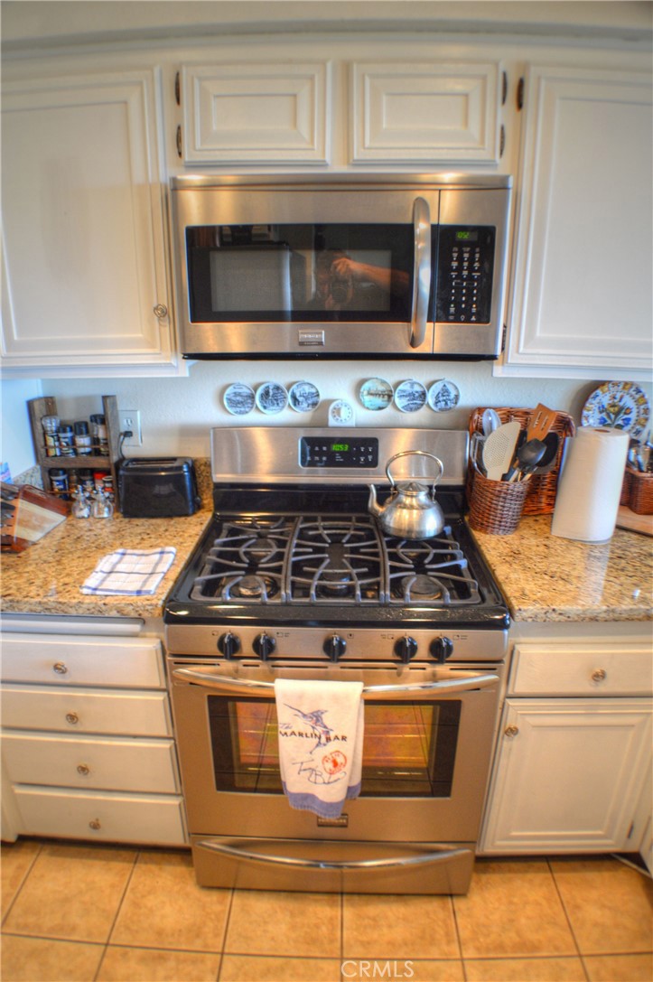 146 Avenida Baja San Clemente, CA 92672 - Photo 27 of 41 a stove top oven sitting inside of a kitchen