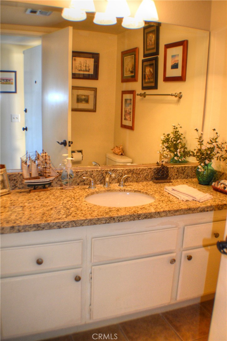 146 Avenida Baja San Clemente, CA 92672 - Photo 30 of 41 a view of a kitchen with granite countertop cabinets