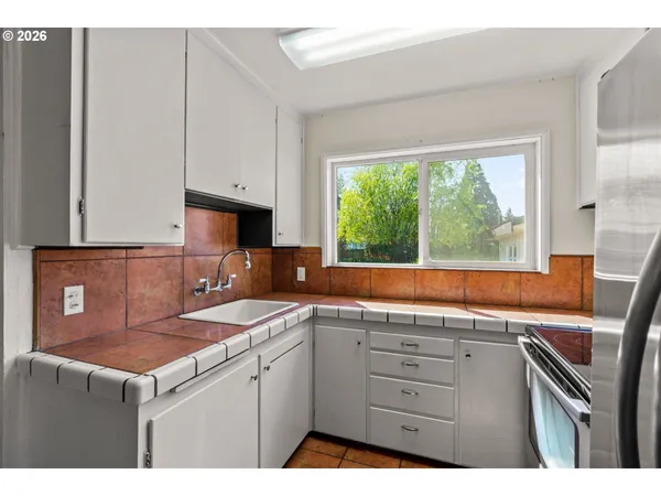 a kitchen that has a sink and a stove in it