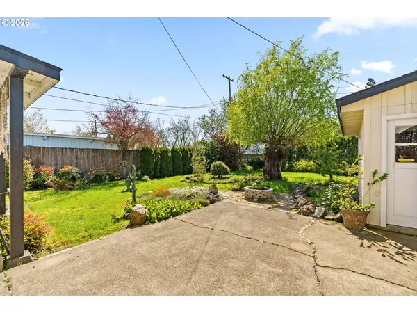 a backyard of a house with plants and outdoor seating