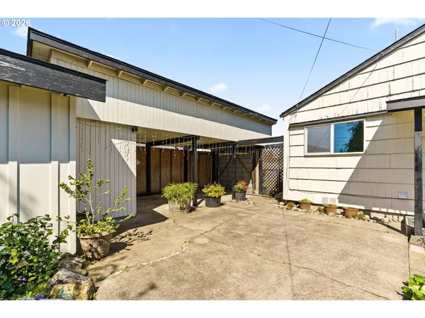 a backyard of a house with table and chairs