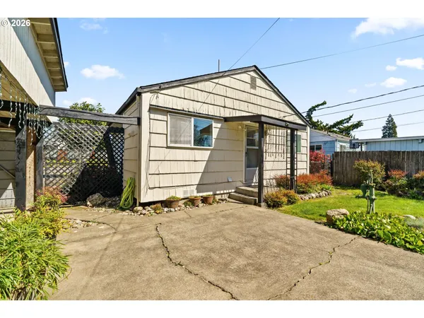 a backyard of a house with table and chairs