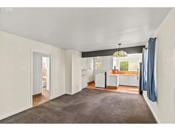 a view of a livingroom with wooden floor and a window