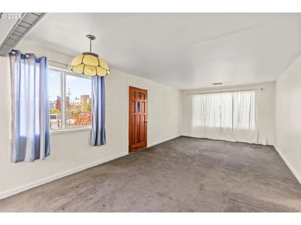 a view of an empty room with a window