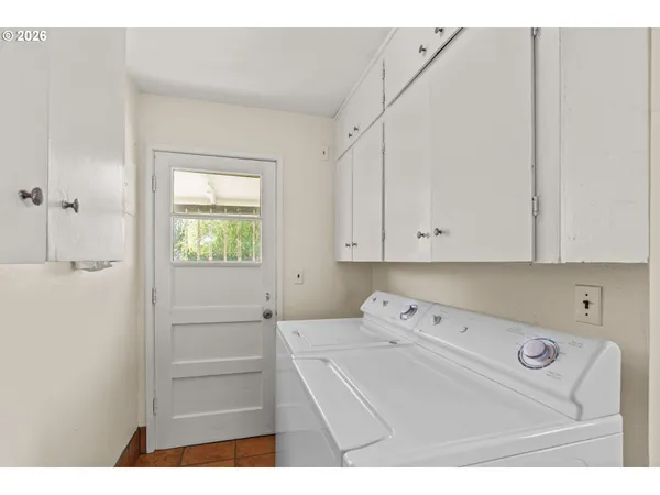 a utility room with closet dryer and washer