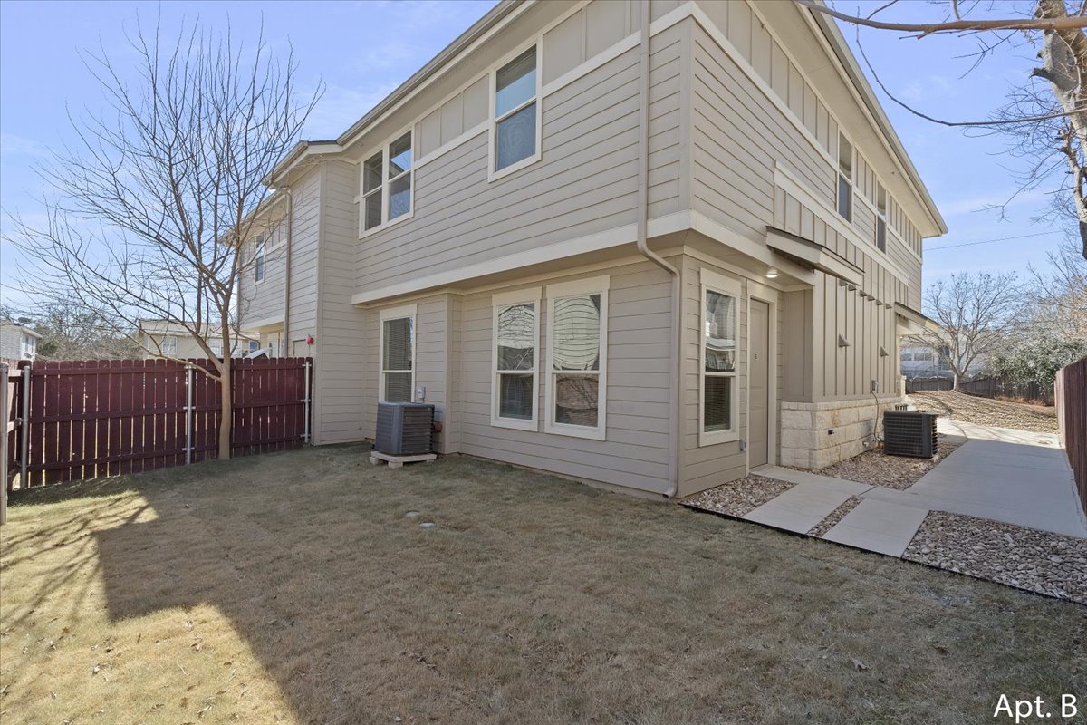 2225 Katy Lane, Unit B Georgetown, TX 78626 - Photo 4 of 22 Rear view of house featuring a fenced backyard and board and batten siding