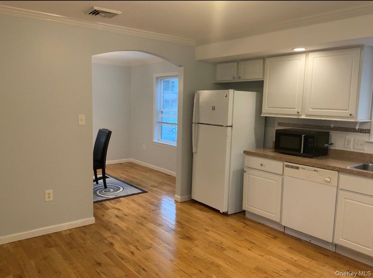 115 A High Street Peekskill, NY 10566 - Photo 7 of 17 a kitchen with granite countertop a refrigerator and a stove top oven