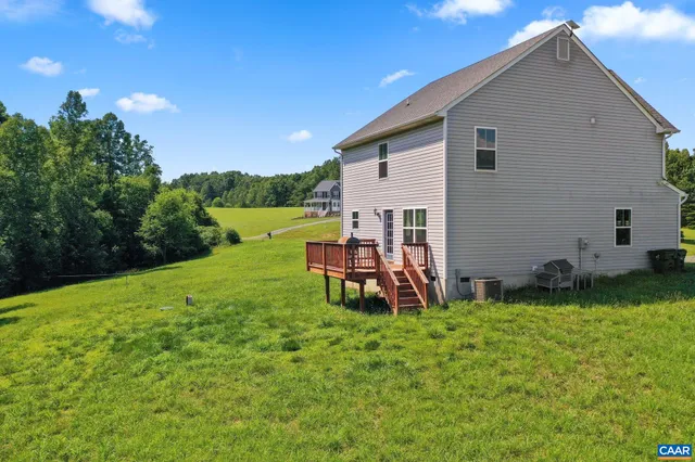 a view of a house with backyard porch and sitting area