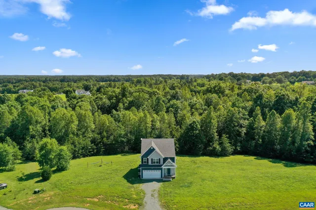 a view of a green field with an trees